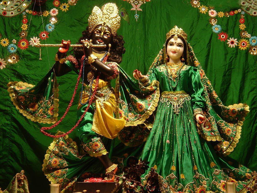 Radha Krishna Temple Murti in Ornate Green Silk Attire with Floral Decorations HD wallpaper