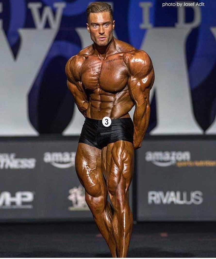 Chris Bumstead Bodybuilding Stage Pose With Oiled Musculature and Competition Number HD phone wallpaper