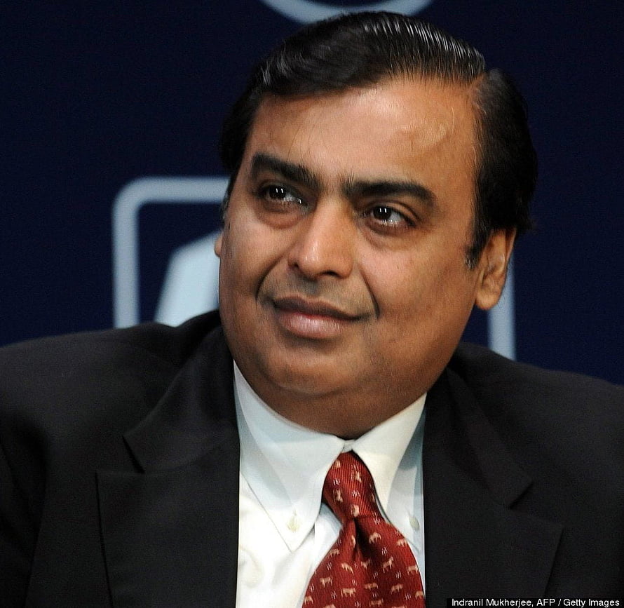 Mukesh Ambani in a dark suit and red patterned tie at a formal corporate event HD wallpaper