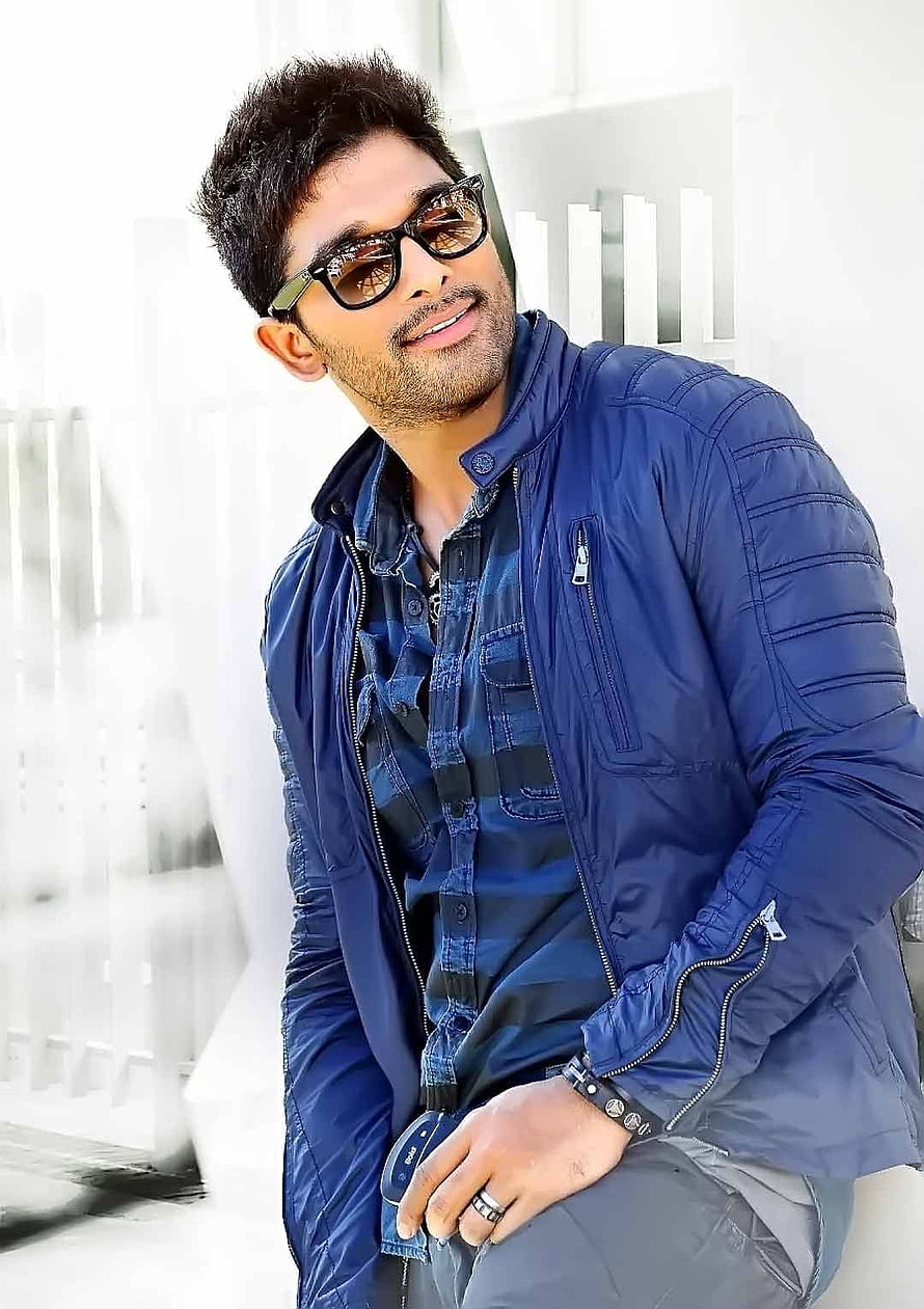 Allu Arjun in a blue bomber jacket and sunglasses posing against a white architectural background HD phone wallpaper