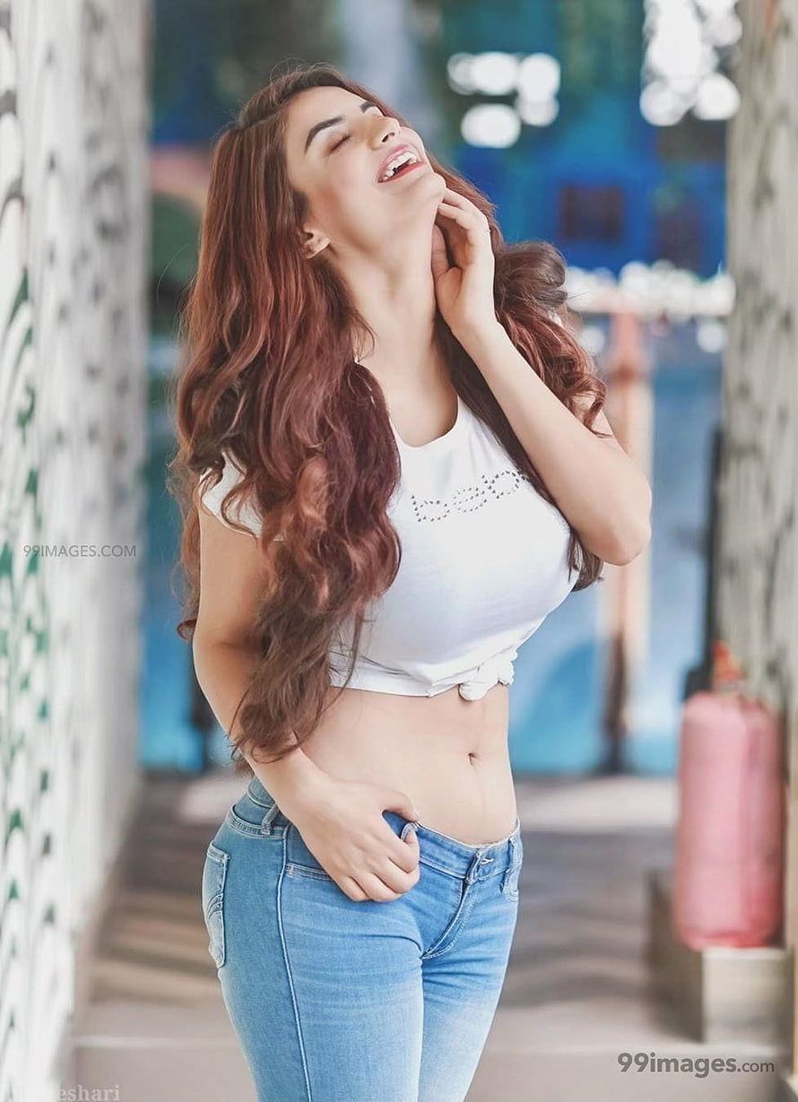 Anveshi Jain in White Crop Top and Blue Jeans with Long Wavy Hair HD phone wallpaper