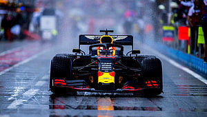Max Verstappen Red Bull Racing Formula 1 Car on Wet Track HD wallpaper