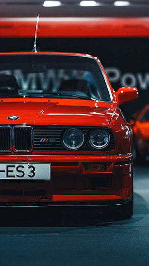 Red BMW E30 M3 Front Grille and Headlights Close-Up at Auto Show HD phone wallpaper