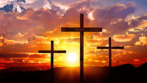 Three Wooden Crosses Silhouetted Against a Dramatic Sunset Sky HD wallpaper
