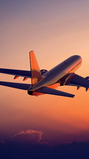 Commercial Jetliner Cruising Through Golden Sunset Sky With Dramatic Clouds Below HD phone wallpaper