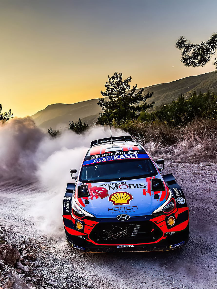Hyundai i20 WRC Rally Car Drifting on Gravel Road at Sunset HD phone wallpaper