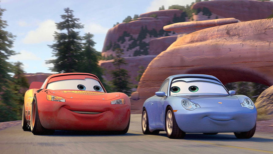 Cars Movie Scene Featuring Lightning McQueen and Sally Carrera Driving Through Desert Canyon HD wallpaper