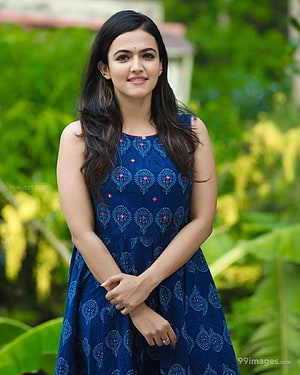 Aparna Das in a Blue Embroidered Dress with Green Garden Background HD phone wallpaper