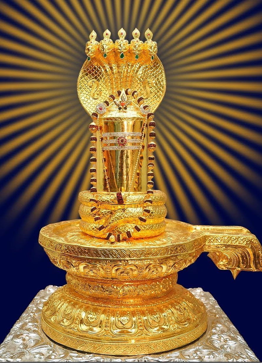 Ornate Golden Shiva Lingam with Multi-Headed Cobra Hood and Radiant Sunburst Background HD phone wallpaper