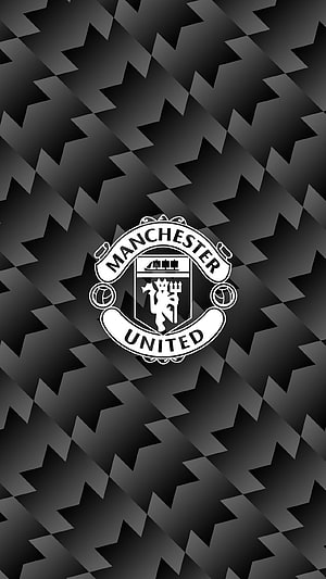 Manchester United Monochrome Crest on Geometric Black Pattern Background HD phone wallpaper