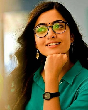 Rashmika Mandanna Portrait in Teal Shirt with Round Glasses and Long Dark Hair HD phone wallpaper
