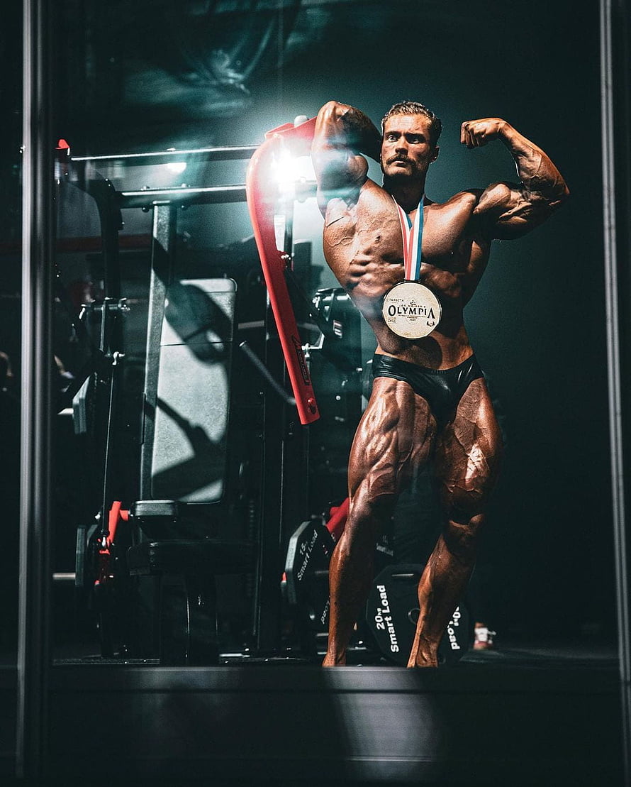 Chris Bumstead Bodybuilder Flexing in Gym with Olympia Medal HD phone wallpaper