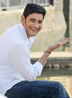 Mahesh Babu Smiling in White Shirt and Jeans by a Water Canal HD phone wallpaper