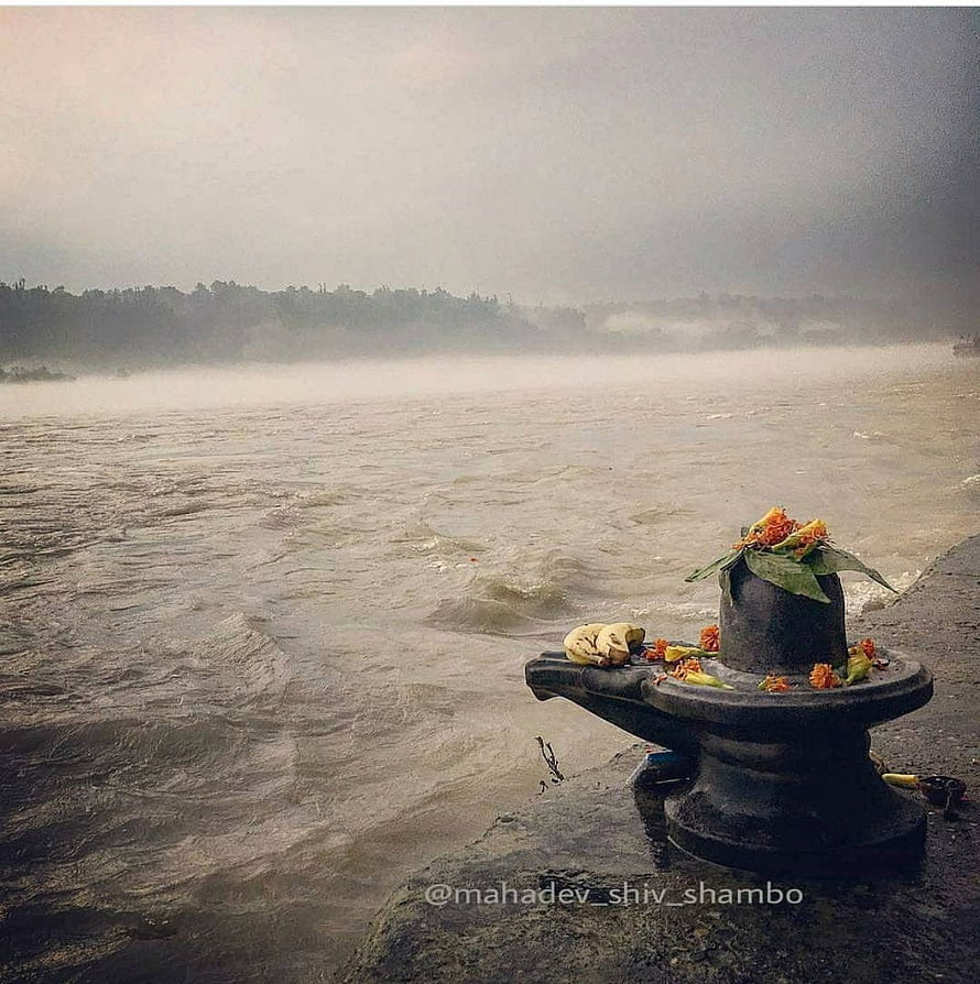 Sacred Shivling Adorned With Marigolds On The Banks Of A Misty River HD phone wallpaper