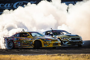Tandem Drift Racing With Thick Tire Smoke On The Track HD wallpaper