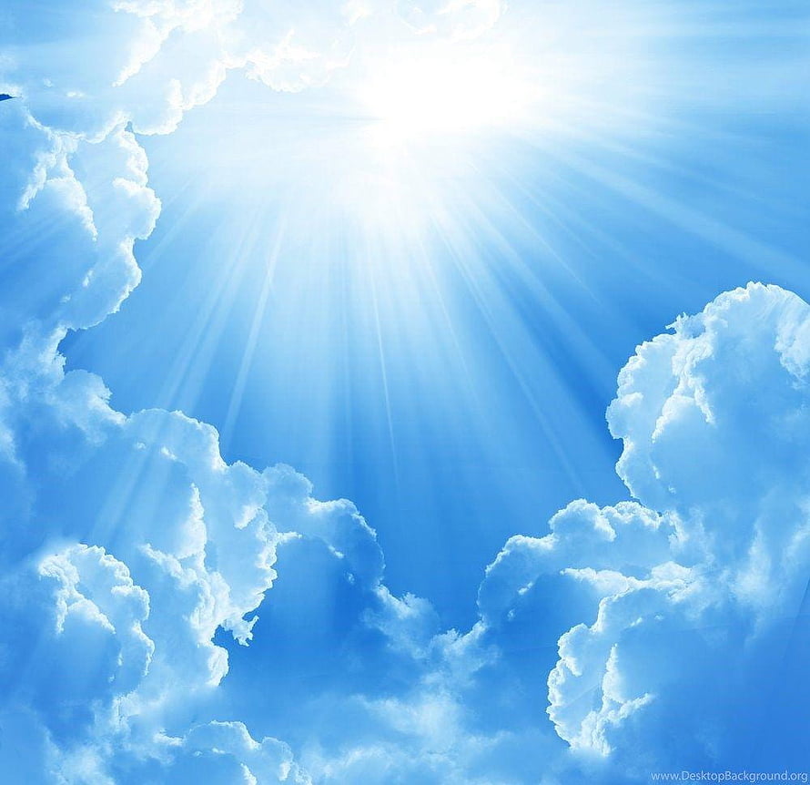Sunbeams Breaking Through Fluffy White Clouds in a Bright Blue Sky HD wallpaper