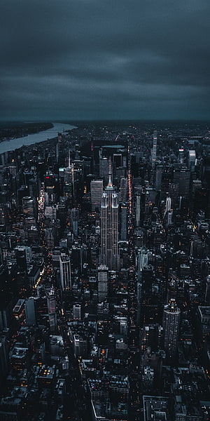 Aerial View of New York City at Night with Empire State Building Under Stormy Skies HD phone wallpaper