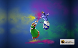 Radha and Krishna Celebrating Holi with Vibrant Colored Powder HD wallpaper