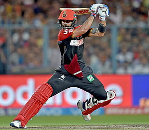 Virat Kohli in Royal Challengers Bangalore kit executing a powerful cricket shot HD wallpaper