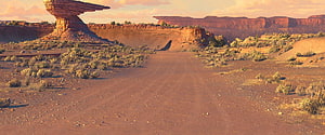Radiator Springs Desert Highway with Red Rock Formations and Arid Landscape HD wallpaper