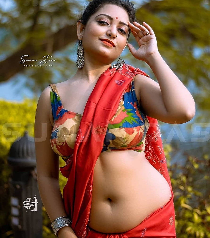Bengali model in vibrant red saree and floral blouse posing outdoors HD phone wallpaper