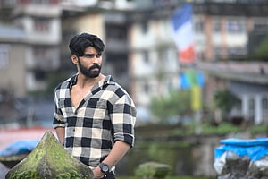 Dhruv Vikram in a black and white checkered shirt with a serious expression HD wallpaper