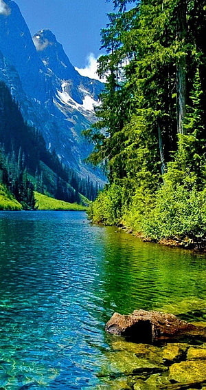 Serene Alpine Lake with Turquoise Water, Snow-Capped Peaks, and Lush Evergreen Forest HD phone wallpaper