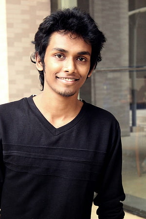 Smiling Young Man in Black V-Neck Shirt Standing Outdoors HD phone wallpaper