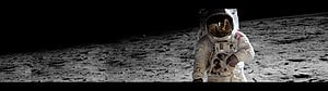 Astronaut in white spacesuit standing on the lunar surface with a black sky and reflective gold visor HD wallpaper