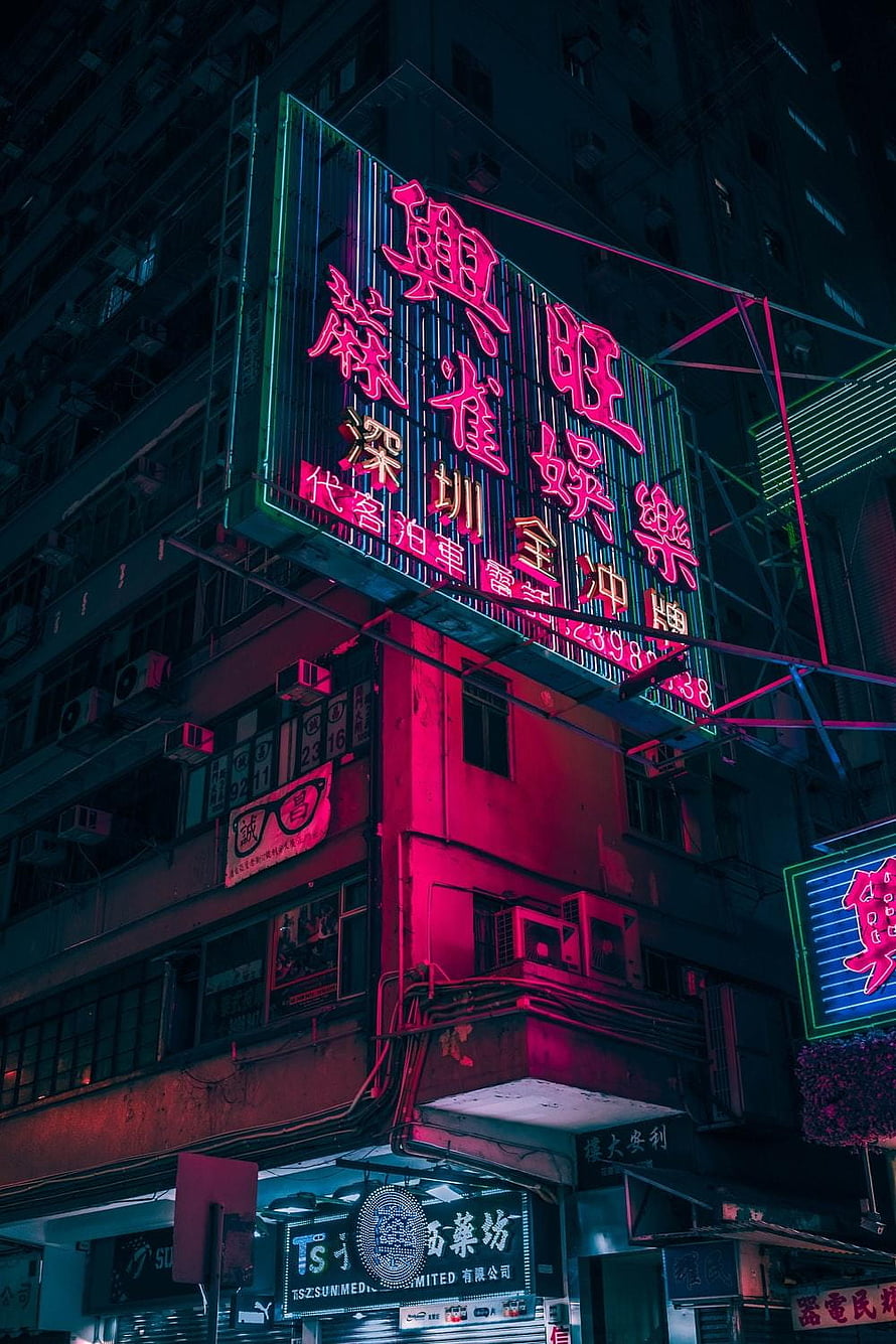 Neon-lit Chinese cityscape at night with glowing signage and dense urban architecture HD phone wallpaper