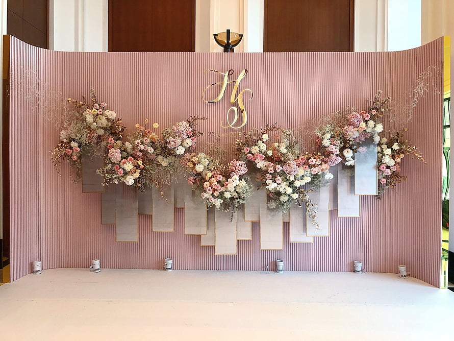Elegant Blush Pink Wedding Stage Backdrop With Floral Arrangements And Gold Monogram HD wallpaper