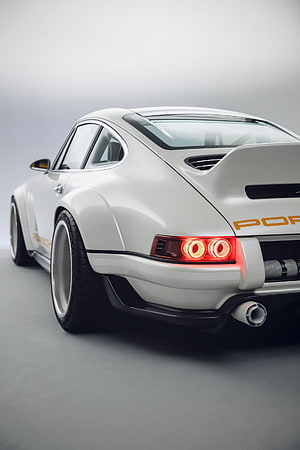 Rear Three-Quarter View of a White Porsche 911 Singer with Widebody Kit and Custom Taillights HD phone wallpaper