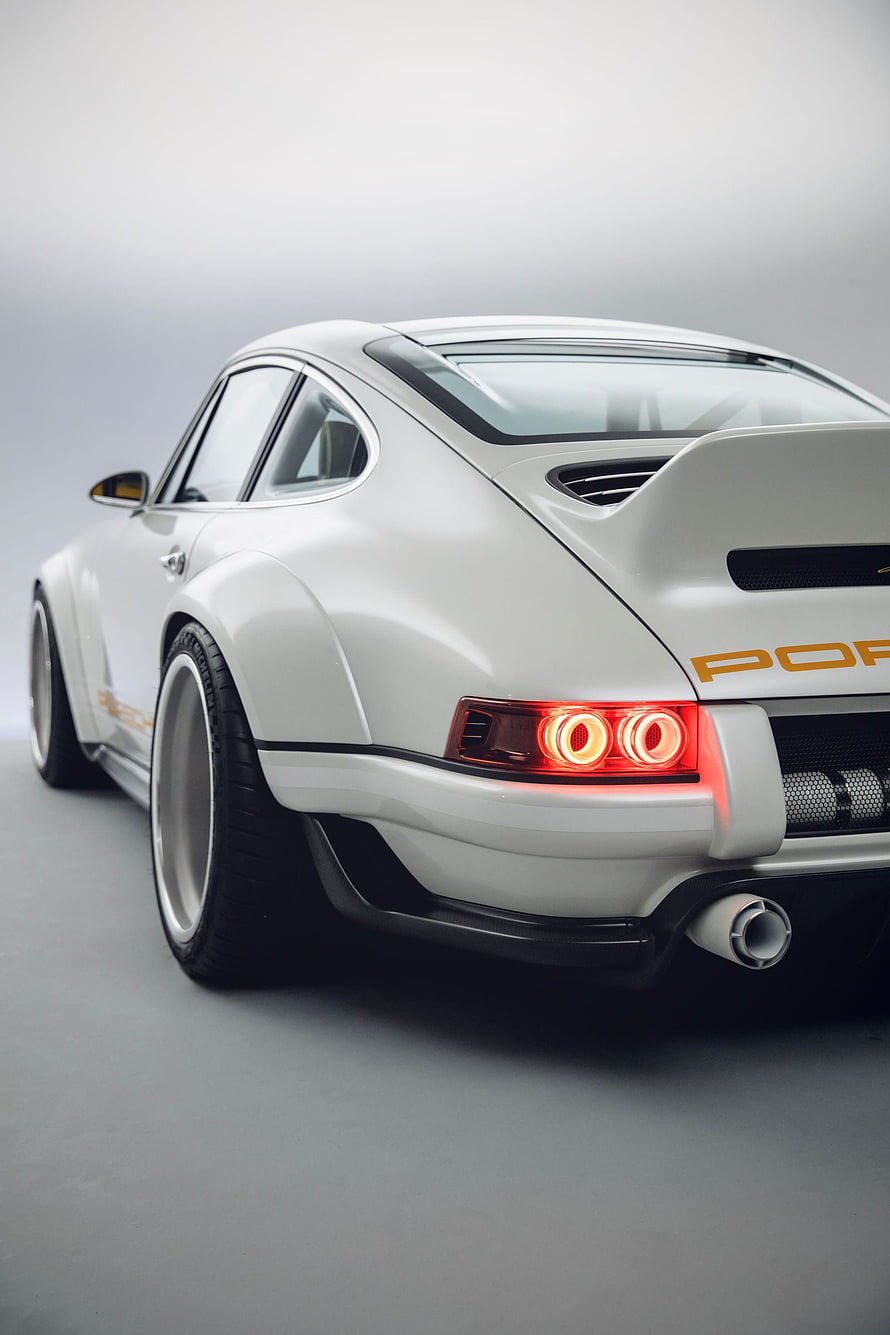 Rear Three-Quarter View of a White Porsche 911 Singer with Widebody Kit and Custom Taillights HD phone wallpaper