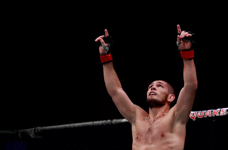 Khabib Nurmagomedov Celebrates Victory in UFC Octagon with Arms Raised HD wallpaper