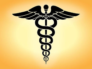 Black Caduceus Medical Symbol with Wings and Serpents on Golden Gradient Background HD wallpaper