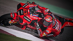 Pecco Bagnaia on Ducati Lenovo GP23 Bike Cornering at Qatar Grand Prix HD wallpaper
