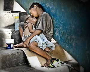 Tender Embrace of Siblings in Manila Street Poverty HD wallpaper