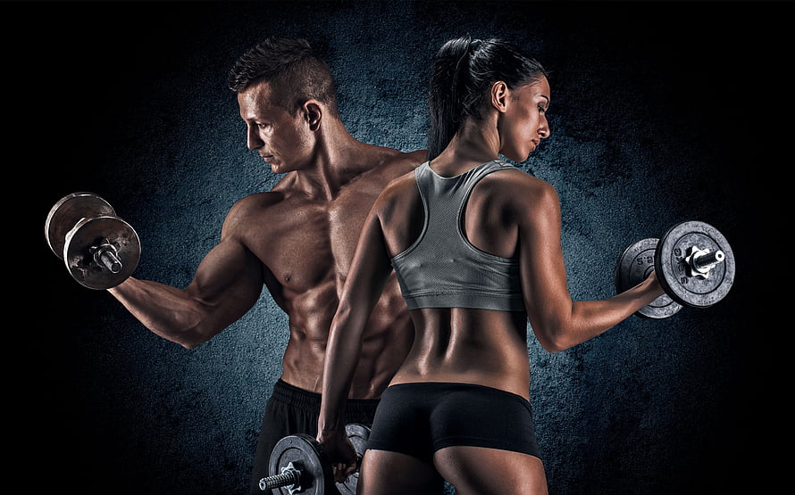Muscular Man And Woman Lifting Dumbbells In Dramatic Gym Lighting HD wallpaper