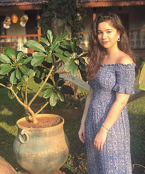 Sara Tendulkar in a Blue Off-Shoulder Dress in a Garden Setting HD phone wallpaper