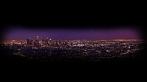 Panoramic Night Cityscape with Purple Skyline Glow and Distant Urban Lights HD wallpaper
