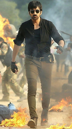 Ravi Teja Action Hero Walking Through Fire and Smoke in Black Shirt HD phone wallpaper