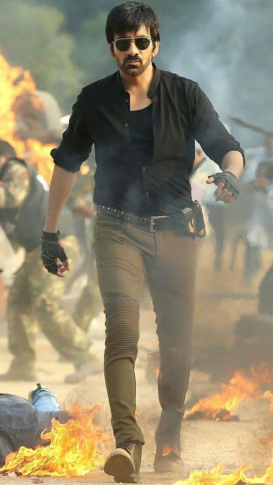 Ravi Teja Action Hero Walking Through Fire and Smoke in Black Shirt HD phone wallpaper