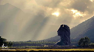 Shiva Statue at Isha Yoga Center with Mountain Backdrop and Dramatic Sunlight HD wallpaper