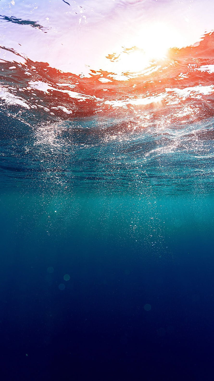 Underwater Ocean Surface with Sunlight Rays and Bubbles in Deep Blue Water HD phone wallpaper