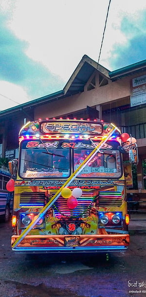 Vibrantly decorated Sri Lankan bus with colorful lights and balloons parked on a street HD phone wallpaper