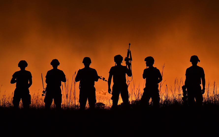 Silhouetted Soldiers Standing in a Field at Sunset with Rifles HD wallpaper