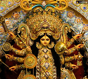 Ornate Durga Puja Idol with Multiple Arms and Golden Jewelry HD wallpaper