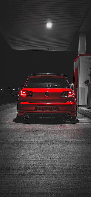 Rear View of a Red Volkswagen Golf GTI Parked at a Gas Station at Night HD phone wallpaper