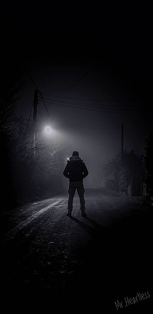 Solitary Figure Standing on a Dark Foggy Road at Night HD phone wallpaper