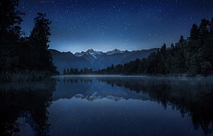 Lake Matheson at Night with Starry Sky and Mountain Reflections in New Zealand HD wallpaper